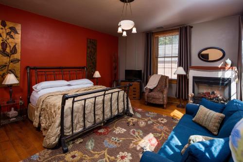 a bedroom with a bed and a blue couch at Farmers Guest House in Galena