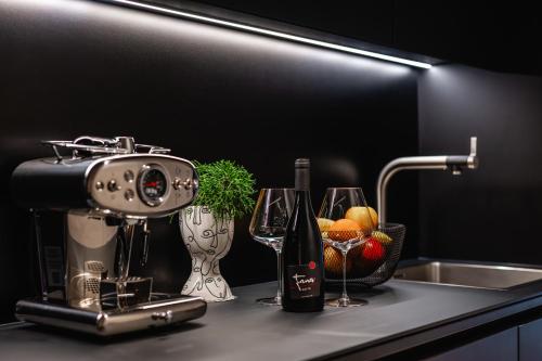 a kitchen counter with a mixer and wine glasses at Fana Estate in Dobrovo