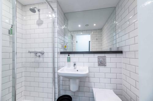 a white bathroom with a sink and a mirror at easyHotel Newcastle in Newcastle upon Tyne