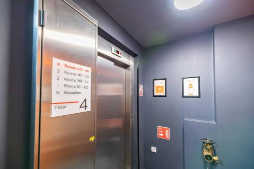 an elevator in a building with a sign on it at easyHotel Newcastle in Newcastle upon Tyne
