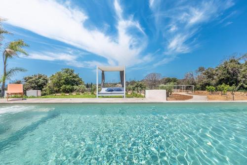 a pool with a gazebo in a yard at Villa Demetra by SalentoInVacanzaCOM in Marina di Pescoluse