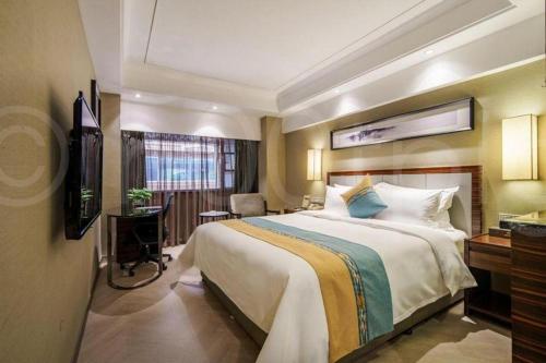 Ένα ή περισσότερα κρεβάτια σε δωμάτιο στο Xiamen Jin Rui Jia Tai Hotel