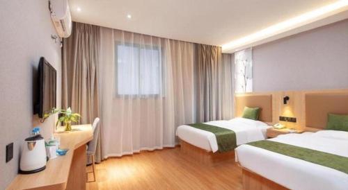 a hotel room with two beds and a window at GreenTree Inn Shanghai Jiading Anting Motor City Express Hotel in Shanghai