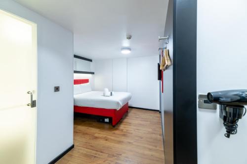 a small room with a bed and a bathroom at easyHotel Newcastle in Newcastle upon Tyne