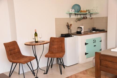 a small kitchen with a small table and chairs at Regina di Dobrota in Kotor