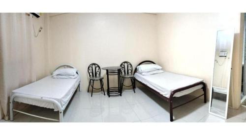 Postel nebo postele na pokoji v ubytování OYO 800 DDD Habitat Dormtel Bacolod