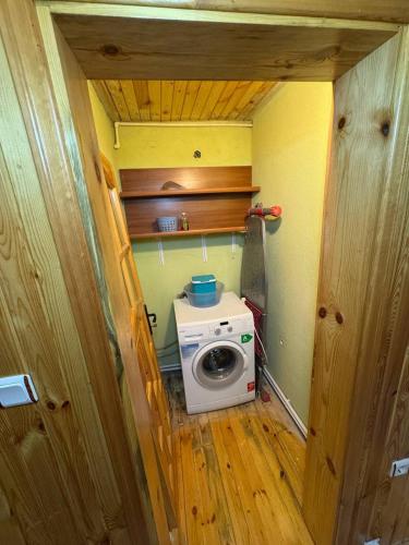 a small bathroom with a washing machine in a room at Zirve Apart in Uzungöl