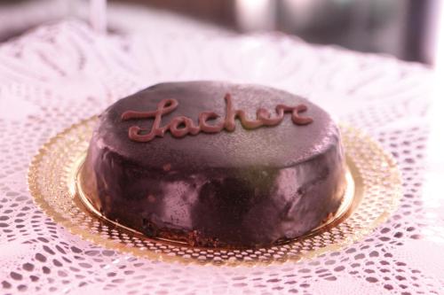 a chocolate cake on a plate on a table at Hotel Stella Alpina in Falcade