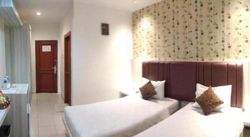 Postel nebo postele na pokoji v ubytování Jelita Tanjung Hotel