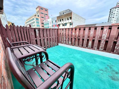a wooden fence with a bench next to a swimming pool at 26 Rangoon Residence 26 in George Town