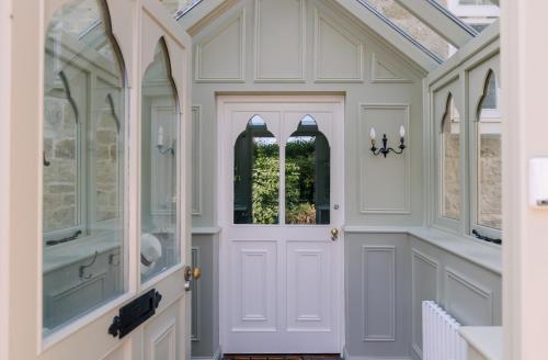 a room with a white door and a glass ceiling at NEW JULY 2025 - Grand Clifftop Duplex with Panoramic Views, Games Room & Stylish Interiors in Shanklin Old Village in Shanklin