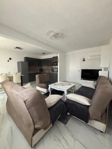 a living room with a couch and a table at Apartman Bella Brčko in Brčko