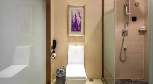 a bathroom with a shower and a phone on the wall at Lavande Hotels· Guizhou Anshun Xi Railway Station in Anshun