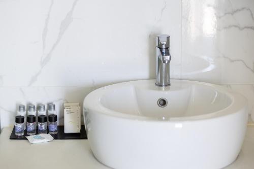 a white bathroom sink with a faucet on a counter at Royal Garden Villas in Bali