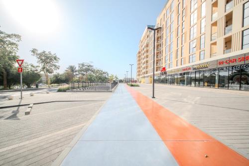 an empty street in a city with a building at The Cloud 9 Penthouse by Blue Cloud Holidays in Sharjah Intl