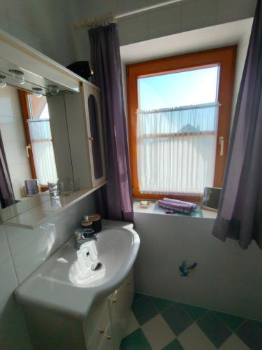 a bathroom with a sink and a window at Appartement Fernblick in Kitzeck im Sausal