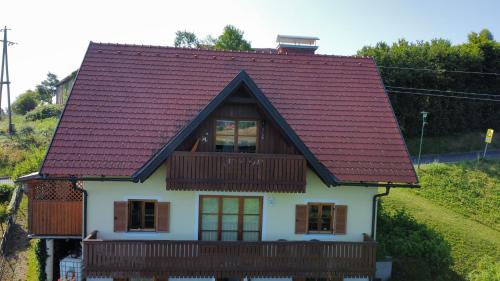 a house with a red roof at Appartement Fernblick in Kitzeck im Sausal