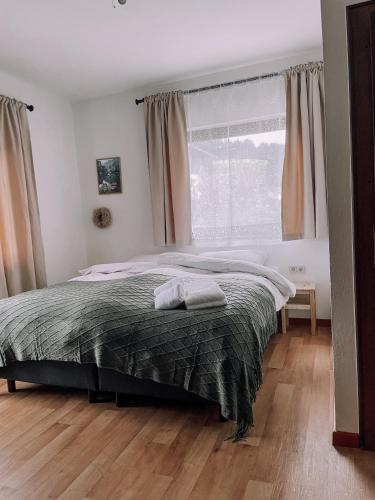 a bedroom with a large bed and a window at Das Luis in Altenmarkt im Pongau