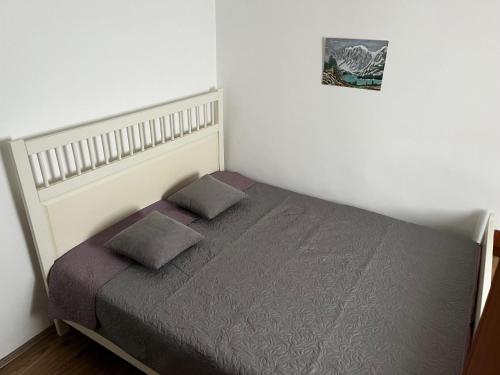 a bedroom with a bed with two pillows on it at Vila FiDa in Gornja Toplica