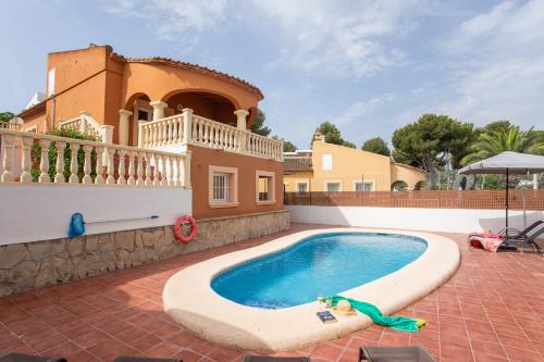 a swimming pool in front of a house at 0301 Villa Maracuya in Balcon del Mar