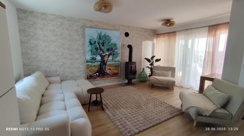 a living room with a white couch and a fireplace at Casa Nova in Njivice