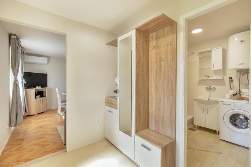 a laundry room with a washer and dryer at Apartman Kovacevic Hn in Igalo
