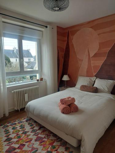 a bedroom with a bed with two towels on it at Maison Maurice Quimper in Quimper