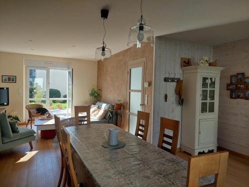 a kitchen and living room with a table and chairs at Maison Maurice Quimper in Quimper