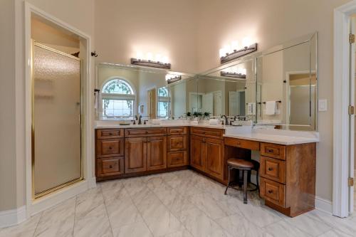 a bathroom with two sinks and a large mirror at Starry Nights - Unforgettable Views Steamy Hot Tub Game Room More in Jasper