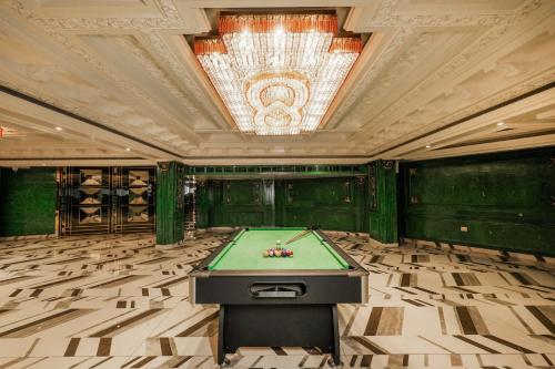 a pool table in a room with a ceiling at Villasita resort By Montrose11 in Kasauli