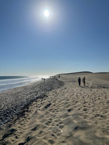 a group of people walking on the beach at 2-bedroom apartment in Playa del Inglés - El Dorado in Maspalomas