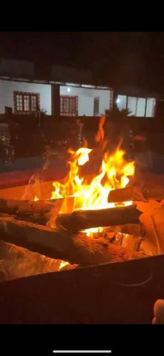 a fire burns in a fire pit at night at Coffee grove homestay in Chikmagalūr