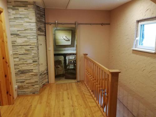 a room with a staircase and a stone wall at Ferienhaus Koppenstein in Schwarzerden