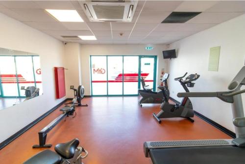 a gym with several treadmills and machines in a room at Spacious 6 Bed Caravan with Decking in Hayling Island