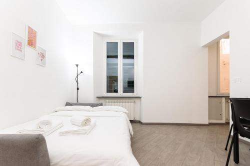 Ένα ή περισσότερα κρεβάτια σε δωμάτιο στο Apartment facing the sea and Navebus Porto Antico