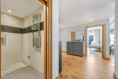 a hallway with a door leading to a living room at Paddington Ex LUX Flat in London