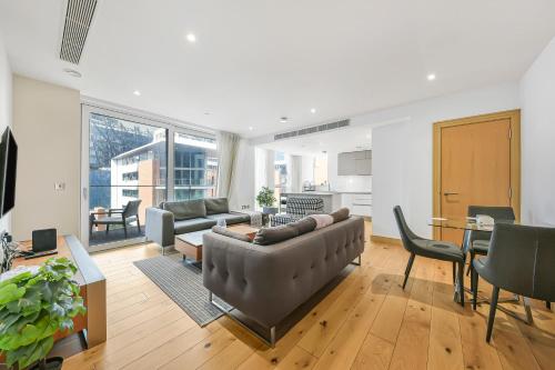 a living room with a couch and a table at Paddington Ex LUX Flat in London