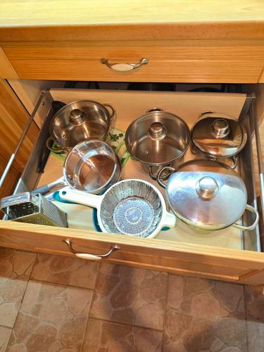 a drawer full of pots and pans in a kitchen at Domeček Trojanovice in Trojanovice