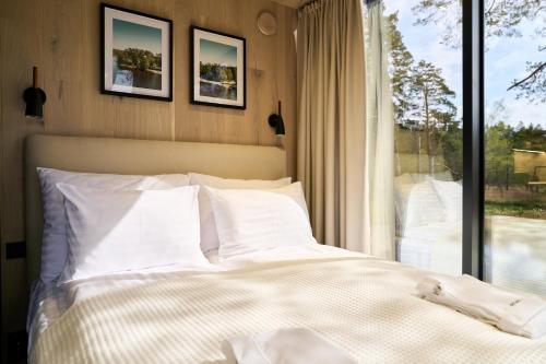 a bedroom with a white bed and a window at Bejas Lux Mirror Houses 