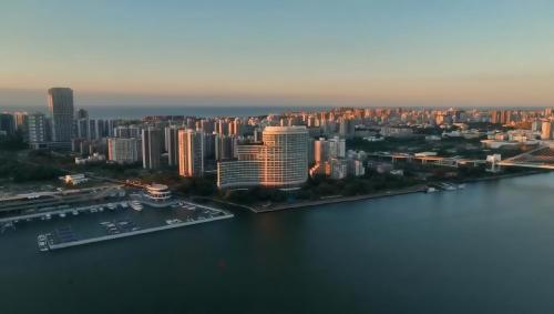 an aerial view of a city with a harbor at InterContinental Haikou Seaview by IHG in Haikou