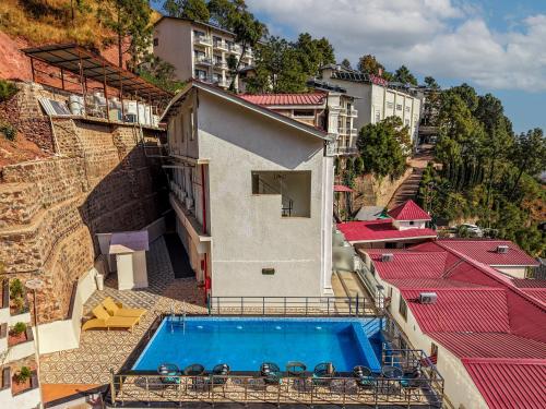 an aerial view of a building with a swimming pool at Villasita resort By Montrose11 in Kasauli