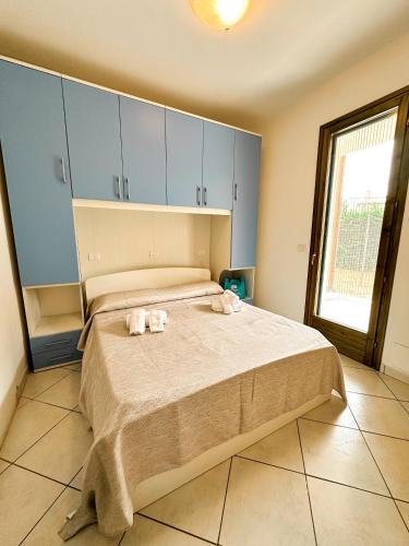 a bedroom with a bed with towels on it at Pomposa Residence in Lido di Pomposa