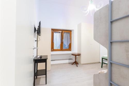 a living room with a window and a table at Casa a Giulianova a due passi dal mare in Giulianova