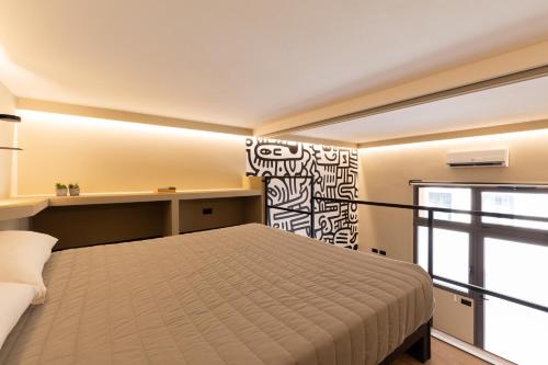 Una cama o camas en una habitación de OlbiaLoft