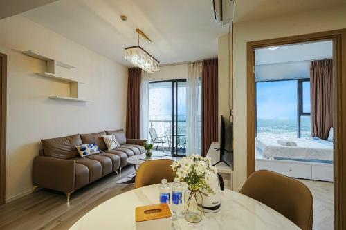 a living room with a couch and a table at Bống Homestay-Luxury Apartment-Vinhomes Grand Park Quận 9 in Gò Công