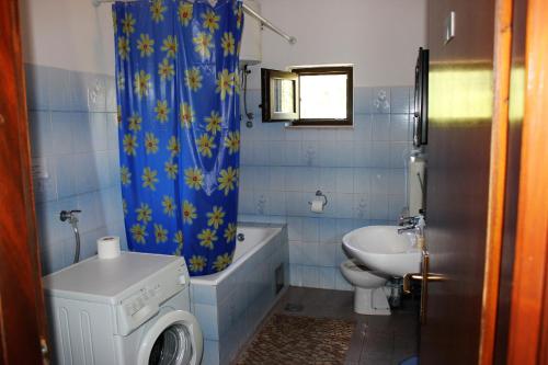 a bathroom with a sink and a toilet and a shower curtain at Azizam hostel in Split
