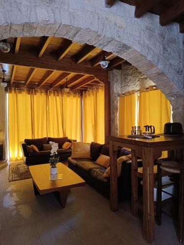 a living room with a couch and a table at Stone Garden Oasis Cottage in Limassol