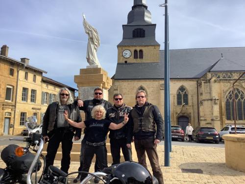 a group of people standing in front of a statue at Auberge de Marville in Marville