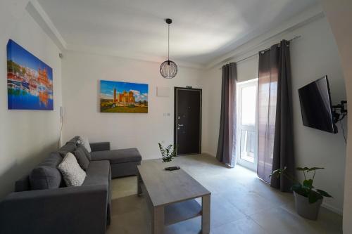 a living room with a couch and a table at Flora Flats 1st, 2nd and 3rd floor appartments no lift in St Paul's Bay