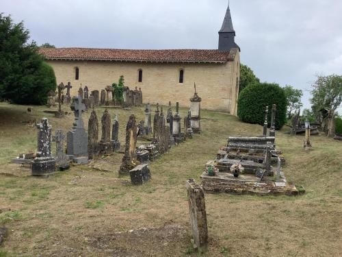 an old cemetery in front of a church at Auberge de Marville in Marville